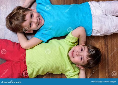 Happy Kids Relaxing Laying On Floor Top View Stock Photo Image Of