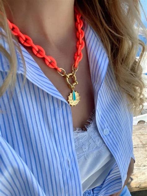 A handamde summer necklace that is made with orange acrylic chain, that ...