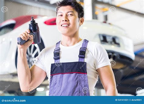 Car Mechanic With Tool In Asian Chinese Auto Workshop Stock Photo