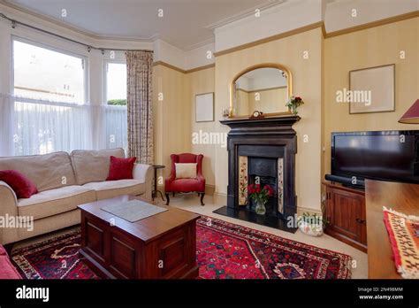 Traditional furnished victorian living room with fireplace Stock Photo ...