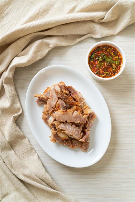 Grilled pork neck or charcoal-boiled pork neck with Thai spicy dipping ...