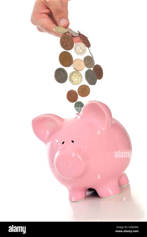 Hand Pouring Sterling Coins Into Piggy Bank Stock Photo Alamy