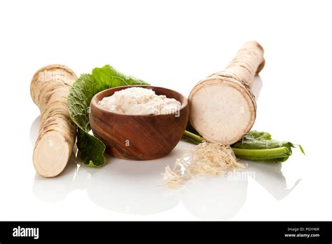 Fresh And Grated Horseradish In Wooden Bowl Isolated On White