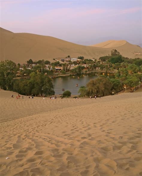 Premium Photo | The oasis town of Huacachina as seen from the sand dune ...