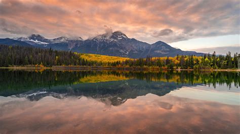 Kolorowe chmury nad górami i jeziorem Patricia Lake