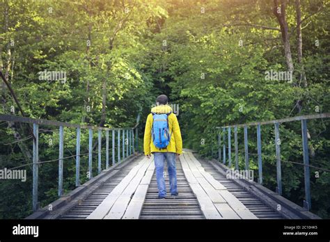 Tourist Man Walking Across Wooden Bridge Stock Photo Alamy