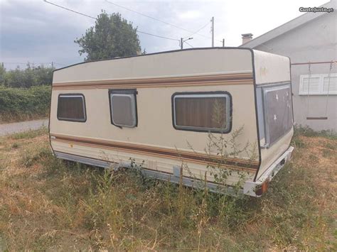 An Old Trailer Is Parked In The Grass