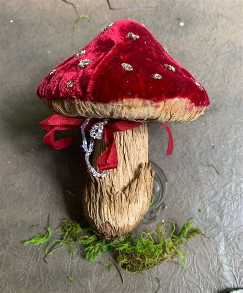 A Mushroom Sitting On Top Of A Piece Of Wood