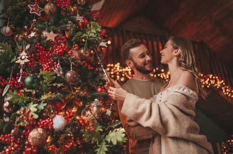 Candid Authentic Happy Married Couple Spending Time Together At Wooden Lodge Xmas Decorated