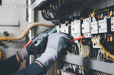 Electrician Engineer Tests Electrical Installations And Wires On Relay