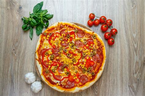 Pizza With Tomato Sauce Salami Green Olives Corn Cheese And Red