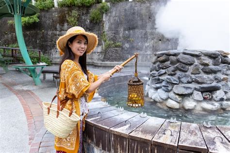 Premium Photo Travel Woman Put A Basket Into Hot Spring For Cooking In Jioujhihze Of