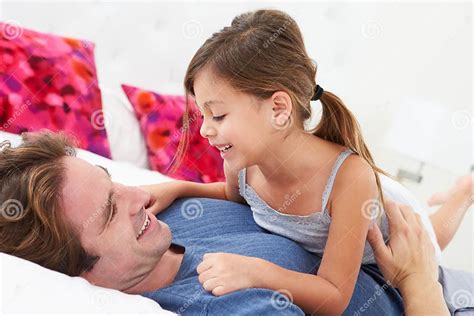 Father And Daughter Lying In Bed Together Stock Image Image Of