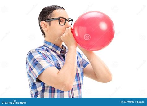 Young Man Blowing Up A Balloon