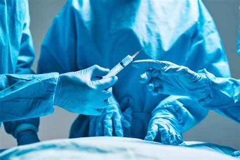 Premium Photo Surgery Operating Room And Hands Of Doctor With Needle