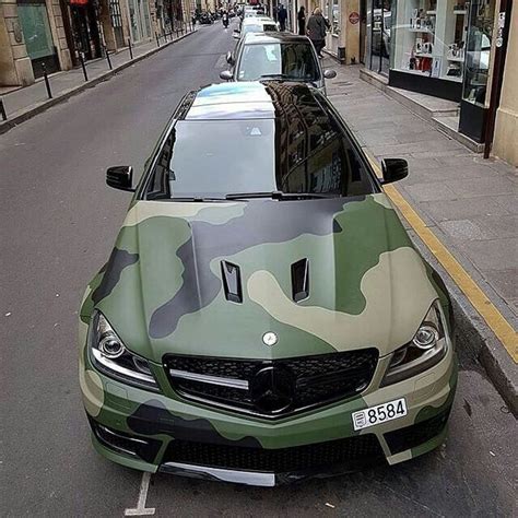 A Camouflage Car Is Parked On The Side Of The Street