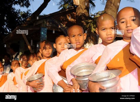 Young Female Monks Waiting To Receive Rice From Donors Pyay Myanmar