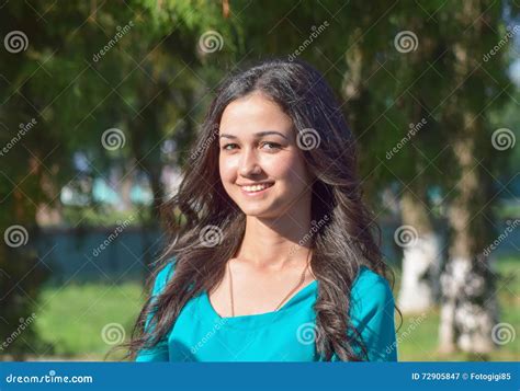 Girl With Toothy Smile And Brown Hair In A Green Dress Stock Image