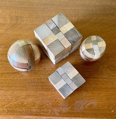 Brain Teaser Wood Puzzle Lot, 4 puzzles, sphere, cylinder, cube ...