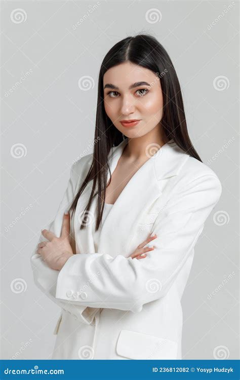 Beautiful Brunette Model Wearing White Business Suit Smiling And Looking At Camera Stock Photo