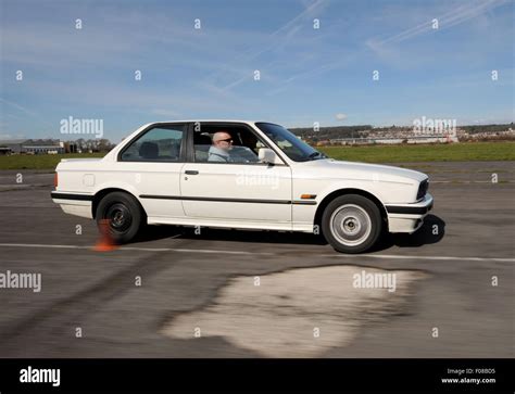 Slalom driving between cones in a BMW car Stock Photo - Alamy