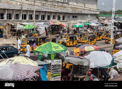 Busy Open Market At African Streets With Busy Traffic With Tuk Tuk Taxi