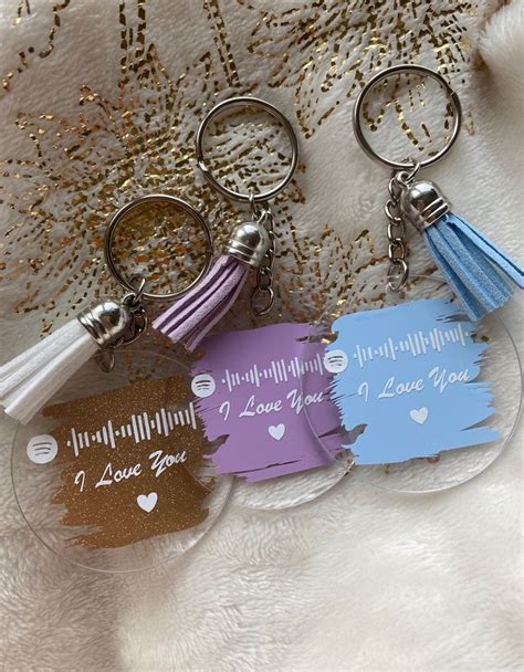 Three Key Chains With Different Designs On Them