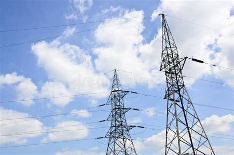 High Voltage Power Lines With Electricity Pylons At Blue Sky Stock