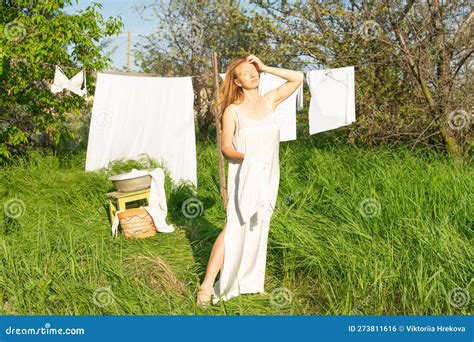 Beautiful Red Girl In Nightie Hanging Laundry Outdoors Village Woman