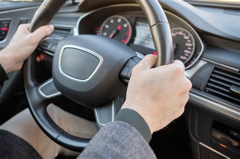 Premium Photo A Man In A Modern Car Hands Holding The Steering Wheel