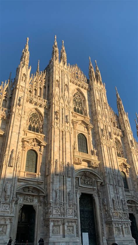 People Are Standing In Front Of An Ornate Building