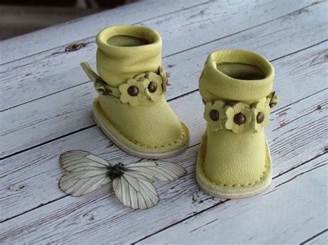 A Pair Of Yellow Shoes Sitting On Top Of A Wooden Floor Next To A Butterfly