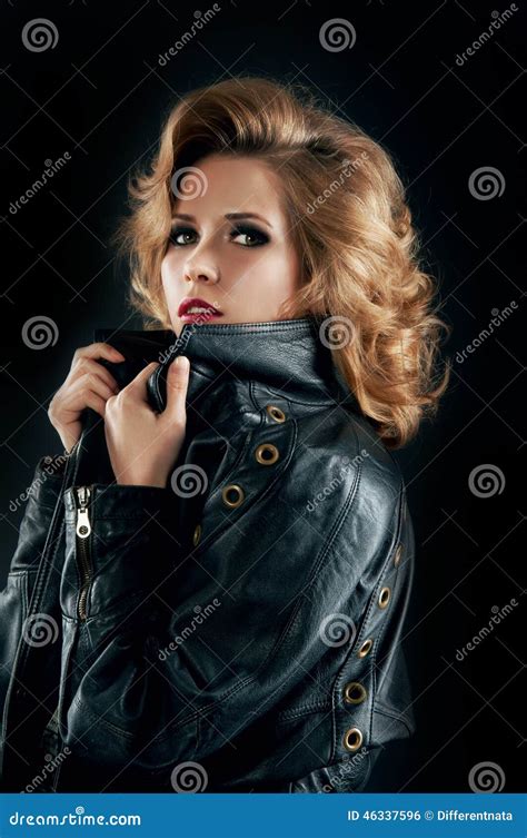 Studio Portrait Of Blonde Woman In Leather Biker Jacket Stock Photo