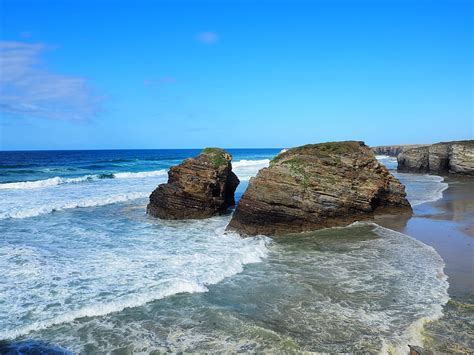 Rocks Near Seashore Viewing Sea Under Blue And White Skies Hd