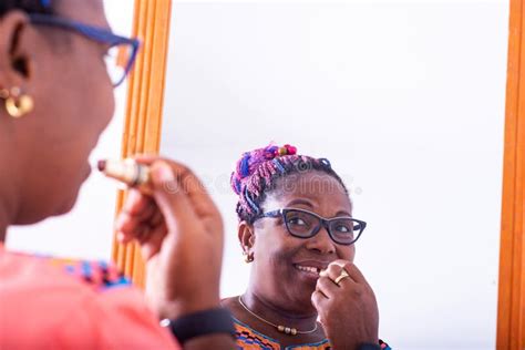 Mature Woman Applying Her Lipstick In Front Of The Mirror Stock Photo Image Of Holding Home