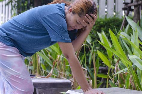 Asian Women Stand Experiencing Dizzy Or Fainting In Park Because Of Hot Weather Stock