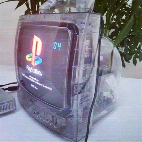 An Old Nintendo Game Console Sitting On Top Of A Table Next To A Potted