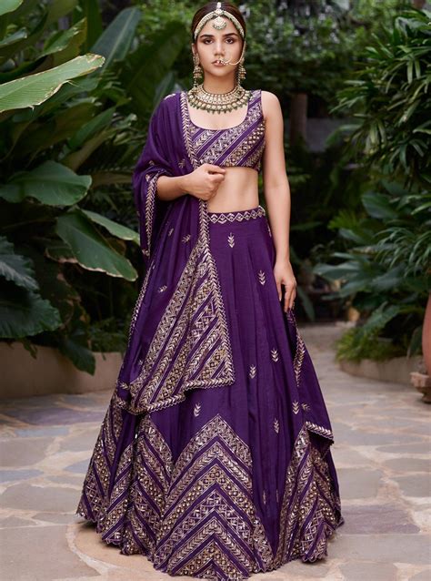 Editor's Note This set features a purple chevron lehenga with a purple dupatta and sleeveless ...