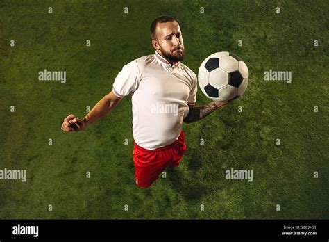 Top View Of Caucasian Football Or Soccer Player On Green Background Of