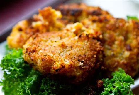 Some Food Is On A White Plate With Lettuce And Breaded Meat In It