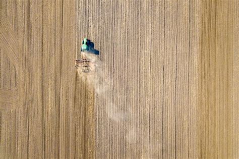 Premium Photo Aerial View Of A Tractor Plowing Black Agriculture Farm