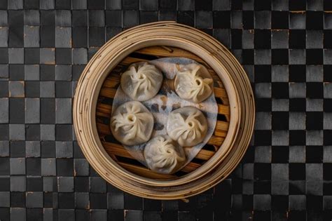 A Wooden Basket Filled With Dumplings Sitting On Top Of A Table Perfect