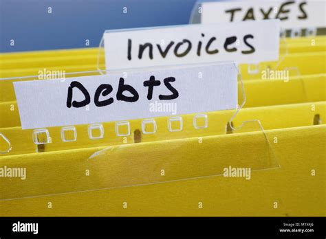 Title Debts On A Yellow Folder In Office Stock Photo Alamy