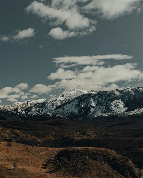 Snow Covered Mountain Under Cloudy Sky · Free Stock Photo