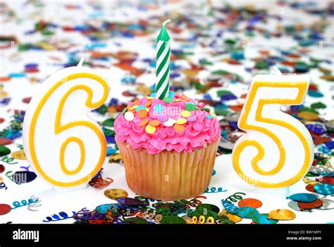 Number 65 Celebration Cupcake With Candle And Sprinkles Confetti In