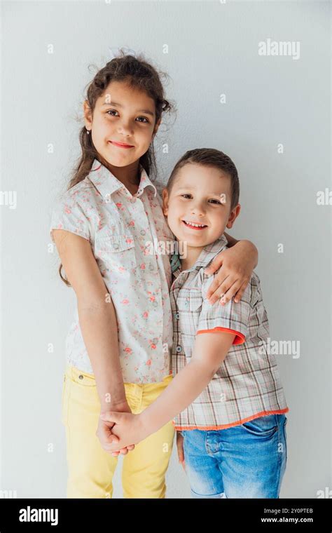 Girl hugging boy holding hands Stock Photo - Alamy