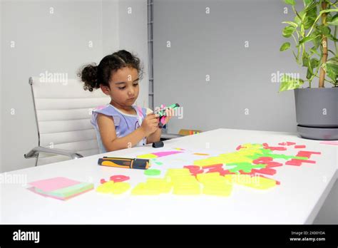 3 Year Old Latina Brunette Girl With Curly Hair Draws As Therapy For Autism And Attention