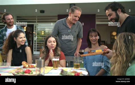 Group Of Cheerful Friends Eating Barbecue Together Bbq Chef Serving