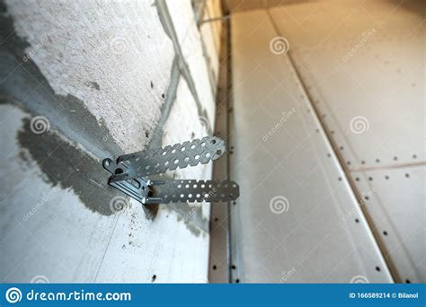 Unfinished Brick Wall In A Room Under Construction Prepared For Drywall