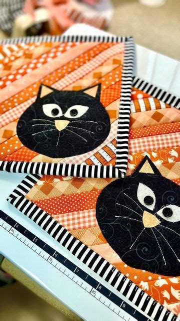 Three Black Cats On Orange And White Quilted Placemats Each With An